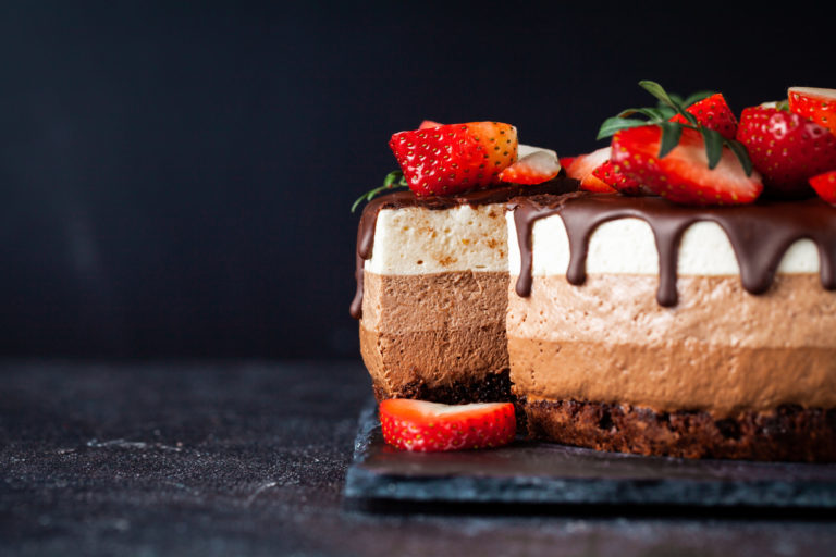 Three layer chocolate peanut butter mousse cake with chocolate drips